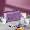 A product bundle display for GleeFull Supplements on a marble surface against a pink background. The layout includes a large purple shipping box featuring the slogan 'FEEL LIKE YOURSELF AGAIN.', three white bottles of Hormonelyte, a purple branded pen, a matching notepad that reads 'REMINDERS WHEN I'M HAVING A MENOPAUSE MOMENT', and a recipe booklet titled 'THE MENOPAUSE Recipes'