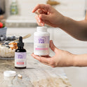GleeFull Meno Morning Fat Burner (amber dropper) and Over 30 Hormone Support (white) bottles on a marble countertop in a kitchen setting.